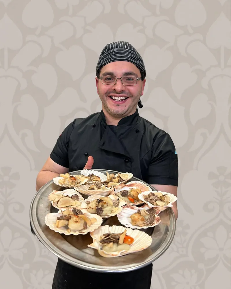Lo chef presenta le cappasante con tartufo durante la cena, Ristorante Alcide
